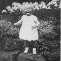 Ann b-1949 smiling in flowers